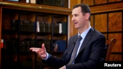 Syrian President Bashar al-Assad speaks during an interview with Russian state television in Damascus on September 12.