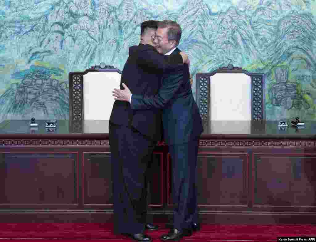 North Korean leader Kim Jong Un (left) and South Korean President Moon Jae-in hug during a signing ceremony near the end of their historic summit in the truce village of Panmunjom on April 27. The leaders embraced warmly after signing a statement in which they declared &quot;there will be no more war on the Korean Peninsula.&quot; (AFP/Korea Summit Press Pool)