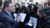 Armenia - National police chief Vladimir Gasparian (L) is confronted by protesters outside a government building in Yerevan, 12Jan2012.