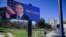 A man walks past a billboard depicting U.S. Secretary of State Antony Blinken displayed in Tirana on February 15.