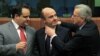 Spanish Economy Minister Luis de Guindos (center) jokes with Luxembourg Prime Minister and then-Eurogroup Chairman Jean-Claude Juncker (right) at a meeting in March 2012.