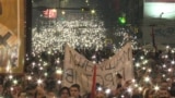 Protesters In Belgrade Light Up Night Sky During Moment Of Silence grab