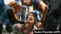 A police officer detains an opposition supporter in Almaty in 2019.