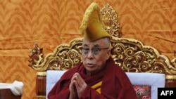 Tibetan spiritual leader the Dalai Lama prays to mark the first day of Losar, the Tibetan New Year of The Water Dragon 2139, at Tsuglakhang Temple in McLeodganj, India, in February 2012.