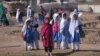 Afghan refugee girls leave school at a refugee camp on the outskirts of Islamabad earlier this year.