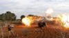 An opposition fighter fires a gun from a village near al-Tamanah during ongoing battles with government forces in Syria's Idlib province, January 11, 2018