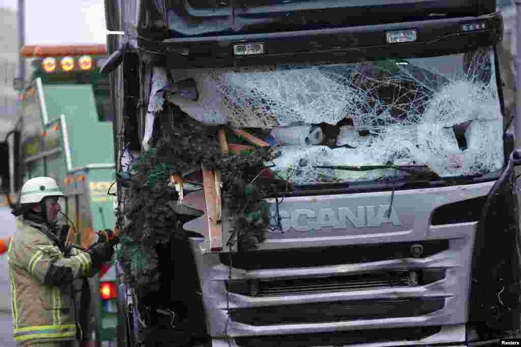 A firefighter stands beside a truck which plowed into a crowded Christmas market in the German capital, Berlin, on December 19, killing 12 people. The suspected Berlin attacker, 24-year-old Tunisian Anis Amri, was shot dead by Italian police on December 23 after a European-wide manhunt. (Reuters/Hannibal Hanschke)