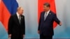 Chinese leader Xi Jinping welcomes Russian President Vladimir Putin after the photo session of the Shanghai Cooperation Organization on September 1.