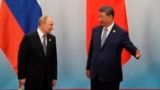 Chinese leader Xi Jinping welcomes Russian President Vladimir Putin after the photo session of the Shanghai Cooperation Organization on September 1.