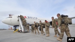 U.S. soldiers from the 438th Medical Unit board a plane on their way home from Afghanistan at the U.S. Transit Center at Manas in March.