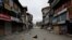 Dogs rest on an empty street during restrictions after the scrapping of the special constitutional status for Kashmir by the government, in Srinagar, on August 11.