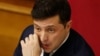 Ukrainian President Volodymyr Zelenskiy reacts during a parliamentary session in Kyiv on March 4, which ushered in a major cabinet reshuffle. 