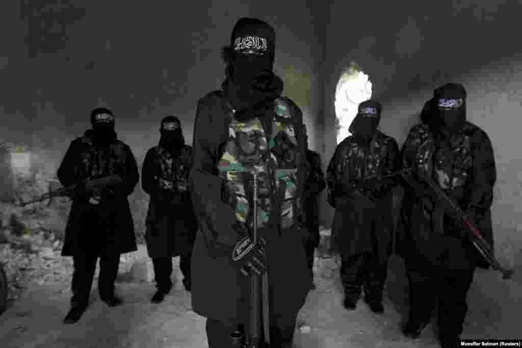 Women who are part of Sawt al-Haq (Voice of Rights) stand with their weapons as they undergo military training in Aleppo, Syria. (REUTERS/Muzaffar Salman)