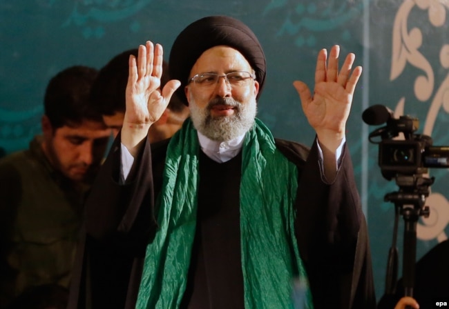 Iranian conservative presidential candidate Ebrahim Raisi waves to supporters on the campaign trail.