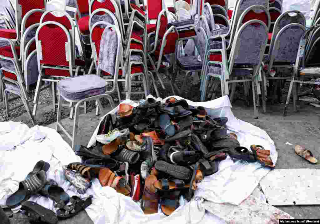 The shoes of victims are seen outside a damaged wedding hall after a blast in Kabul on August 17 that killed at least 63 people. (Reuters/Mohammad Ismail)