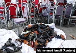 The shoes of victims in the Kabul wedding hall, damaged after the blast.