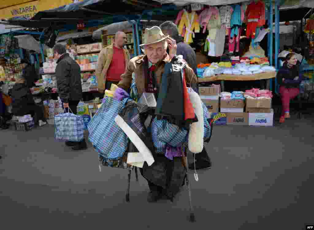 An elderly man sells plastic bags at the central market in Chisinau, Moldova. (AFP/Daniel/Mihailescu)