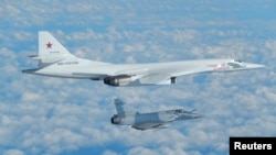 A Russian Blackjack bomber Tu-160 is intercepted and escorted by a French Mirage military fighter above French coast in this image taken and distributed by the French Air Force, February 9, 2017