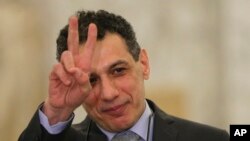 Nizar Zakka a Lebanese citizen and permanent U.S. resident who was released in Tehran after nearly four years in jail on charges of spying, flashes victory sign at the presidential palace, in Baabda, east of Beirut, Tuesday, June 11, 2019.(AP Photo/Hussei