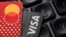 Illustration shows Euro banknotes, Visa and Mastercard cards
