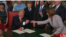 U.S. President Donald Trump hands out pens as he signs bills shortly after his inauguration on January 20.