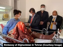 This photo shows one of the injured handcuffed to his hospital bed in Iran.