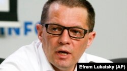 Ukrainian journalist Roman Sushchenko speaks during a press conference in Kyiv on September 11.