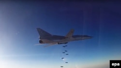 A still image shows a Russian Tupolev Tu-22M3 long-range bomber based in Iran dropping off bombs at an unknown location in Syria.