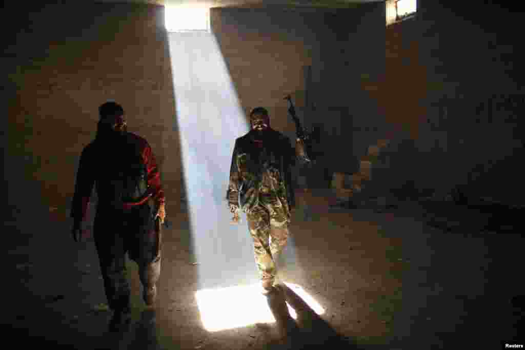 Free Syrian Army fighters smile in a bunker used for shelter from fighter jet air strikes in Aleppo. (REUTERS/Ahmed Jadallah)