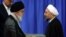 Iranian Supreme Leader Ayatollah Ali Khamenei (left) gives an endorsement letter to newly elected President Hassan Rohani during a ceremony for his confirmation as Iran's president in Tehran on August 3.