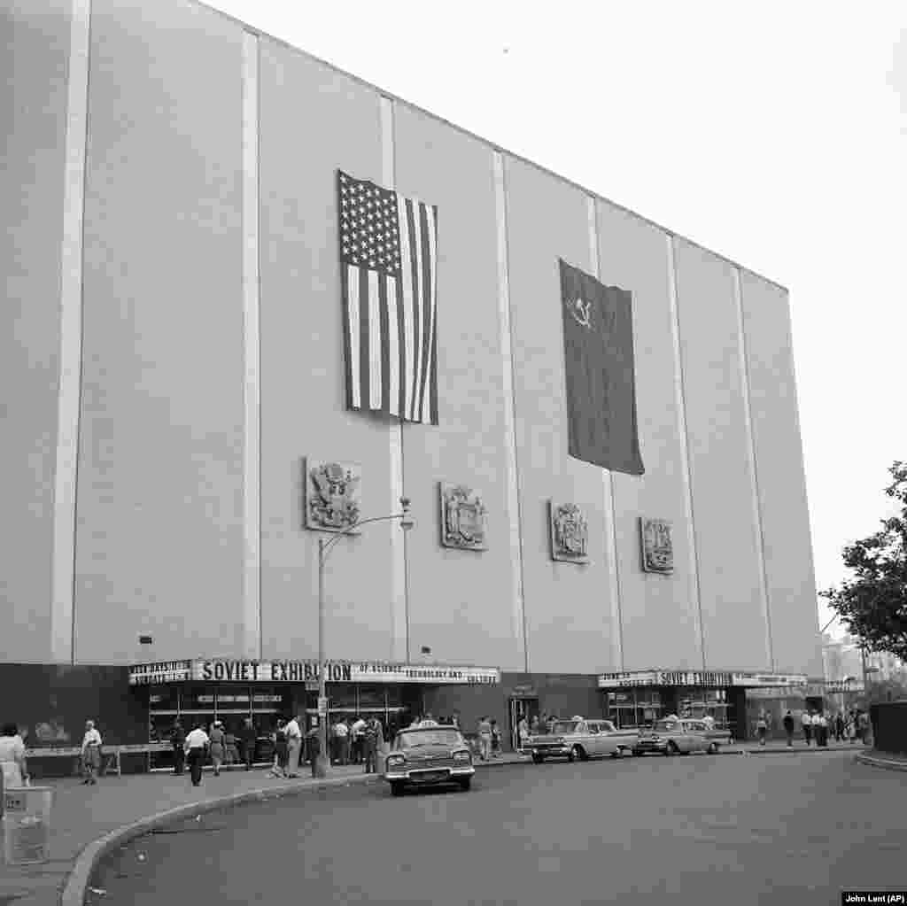 U.S. and Soviet flags ripple on the front of the New York Coliseum as the Soviet exhibition opens in June 1959.