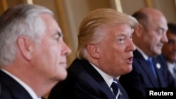 U.S. President Donald Trump talks beside Secretary of State Rex Tillerson. File photo