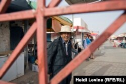 A Tunisian waits by the locked gate to the Libyan market in Ben Gardane, located close to the border with Libya, where the local economy is largely dependent on the smuggling of contraband.