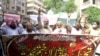 People hold a banner reading in Arabic, "I will sacrifice my parents for the Prophet's honor" during a protest in Hyderabad on July 30 to support the man who killed a man accused of blasphemy.