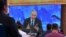 Journalists watch Russian President Vladimir Putin during his annual press conference, via video link from the Novo-Ogaryovo state residence, in Moscow on December 17, 2020.
