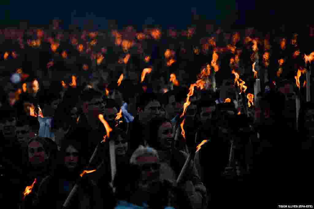 Hungarians participate in a traditional torchlit commemorative march held on October 22, the eve of the 68th anniversary of the 1956 revolution.&nbsp;