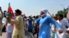 Supporters of imprisoned ex-Prime Minister Imran Khan dance at a rally last month in Pakistan's Peshawar.