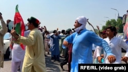 Supporters of imprisoned ex-Prime Minister Imran Khan dance at a rally last month in Pakistan's Peshawar.