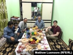 Reporter Matthew Luxmoore (right) with Abdukholik Gadoev, his friends Azam and Ismail, and one of his many grandchildren.