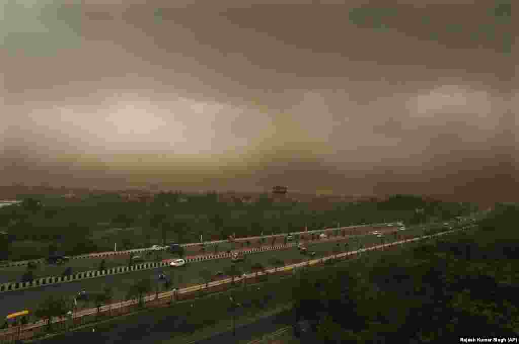 A dust storm accompanied by rain is seen over the skyline of Lucknow in northern India. India is currently having its monsoon season, which lasts until September. (AP/Rajesh Kumar Singh)