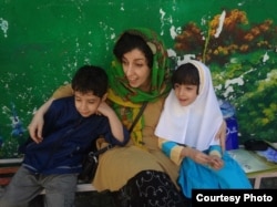 Iran -- Iranian human rights activist, Narges Mohammadi (C), with her children, Ali (L) and Kiana, undated.