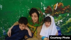 Iranian human rights activist, Narges Mohammadi with her children, Ali (left) and Kiana (right) file photo