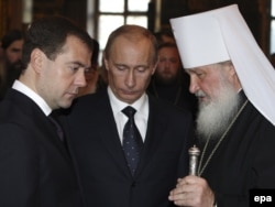 Will Russian President Vladimir Putin (center) use high-profile meetings abroad by Prime Minister Dmitry Medvedev (left) and Orthodox Patriarch Kirill (right) to build real bridges, or to execute tactical moves in a mounting confrontation with the West?