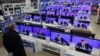 A man looks at televisions in a Moscow showroom as Russian Prime Minister Dmitry Medvedev answers questions in December.