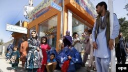 Afghan people displaced from Kunduz demand food and shelter at a government protest in Kabul on October 7.