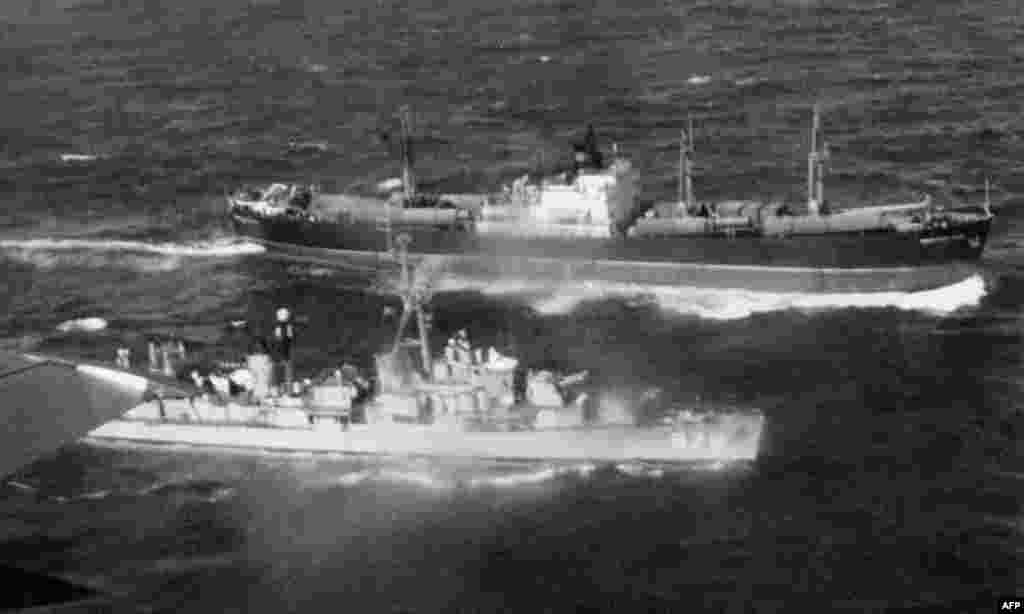 A U.S. destroyer stops a Soviet cargo in order to check the freight on November 12, weeks after Krushchev announced the missile removals over Radio Moscow.