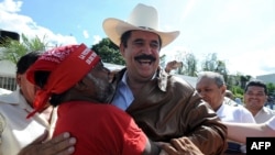 Supporters greet ousted Honduran President Manuel Zelaya as he arrives at the Brazilian Embassy in Tegucigalpa on September 21.