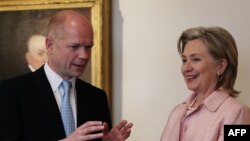 U.S. Secretary of State Hillary Clinton and British Foreign Minister William Hague chat in Washington.