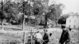 East German border police set up barbed wire along the border between East and West Germany.