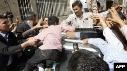 Iranian President Mahmud Ahmadinejad is greeted by well-wishers after voting in Tehran on June 12.